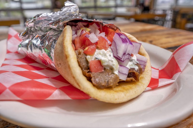 Gyro in a pita with lamb, tomatoes, onions and tzatziki